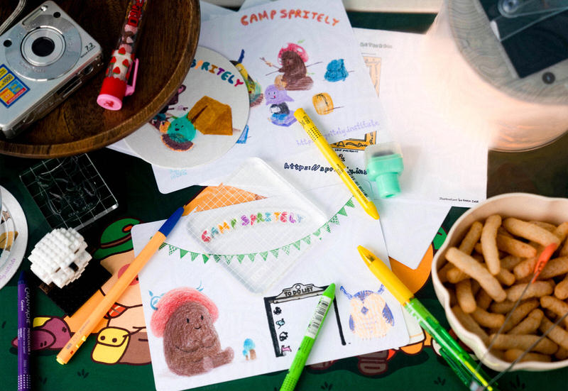 customizing a blank 5x7 postcard with a stamp that reads "Camp Spritely" in bubble letters